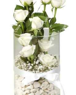 9 beyaz gül, dekoratif taşlar ve cipsofilya ile zarif bir cam vazoda sunulmuş. Saflık ve zarafeti simgeleyen bu buket, her ortama uyum sağlar.